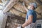 Worker in His 30s Replacing Old Attic Mineral Wool Insulation