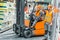 worker and his senior colleague working with forklift machine