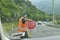 Worker hold Stop sign on highway