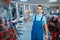 Worker holds aluminum stepladders in tool store