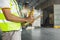 Worker Holds a Clipboard Controlling the Loading of Cargo into Shipping containers. Packaging Boxes Goods. Loading Dock.