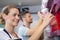 worker in ice cream parlour refilling plastic spoon dispenser