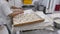 Worker in industrial bakery preparing pretzels for baking