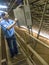 Worker inside a grain storage silo filled with soybean seeds