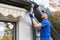 Worker installing house roof gutter system