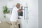 Worker installing modern built-in oven in kitchen