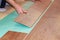 Worker installing new laminate flooring