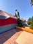 Worker installing a tent on a residential villa for termite fumigation