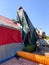 Worker installing a tent on a residential villa for termite fumigation