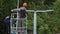 Worker installs lighting pole