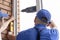 Worker installs windows craftsmen screw frame to the wall Repair in high-rise building