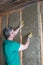 Worker insulates a country house of mineral wool