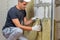 Worker insulating a room wall with mineral rock wool thermal insulation