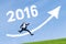 Worker jumps with numbers 2016 and upward arrow in sky