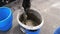 Worker Kneads a Building Mixture in a Plastic Bucket with His Hands. Slow Motion