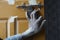 worker labour dirty hand holding steel aldrop door lock on brown door,