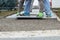 Worker lay down the stone plates on gravel to install footpath