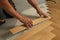 Worker laying parquet flooring