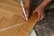 Worker laying parquet flooring.