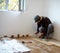 Worker laying parquet in a room