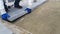 A worker lays paving slabs with a rubber mallet under stretched twine - 12s