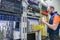 Worker lays telecommunication cables in the server room. A man twists the wires in a modern data center. A technician connects