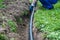 Worker lays a water pipe into the ground