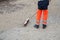 Worker legs on cobblestone maintenance site on main pl