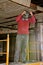 Worker on a lift adjust a dust mask in a renovation of an old warehouse.