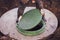 A worker lifts the manhole cover of a sewer well. Construction and maintenance of septic tanks in the village