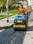 Worker on light vibration roller compactor