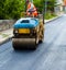 Worker on light vibration roller compactor