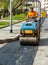 Worker on light vibration roller compactor