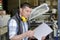 Worker lining up stack paper in cutting machine