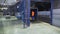 Worker on loader transports boxes in warehous. Scene. Worker standing on loader controls it to transport cargo boxes in