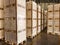 Worker loading and unloading shipment carton boxes and goods on wooden pallet by forklift from container truck to warehouse cargo