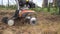 Worker loosen soil with cultivator tractor urban townhouse yard. Gimbal movement