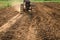 Worker machinery plowed in field