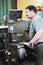 Worker at machining tool workshop