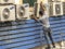 Worker maintains an air conditioner on the facade of a store in downtown Sao Paulo