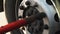 Worker make repair wheels lorry closeup. Man twist screw wrench use tool arm 4K.