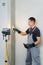 Worker makes final smoothing plaster on the wall.