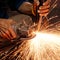 Worker making sparks while welding steel