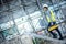 Worker man carrying tool box stepping on aluminium ladder