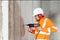 Worker man drilling in concrete on a construction site