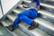 Worker Man Lying On Staircase