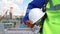 Worker man in uniform holding protective helmet at chemical industrial factory oil plant closeup