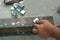 Worker man use hand make dice aluminium square box. capenter work with strong iron on concrete floor. part of zinc material prepar