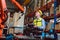 Worker man working with robot arm automate welding machine in modern metal factory. Engineer program robotic in heavy industry