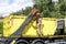 Worker managing crane of a truck and radioactive waste storage container loaded